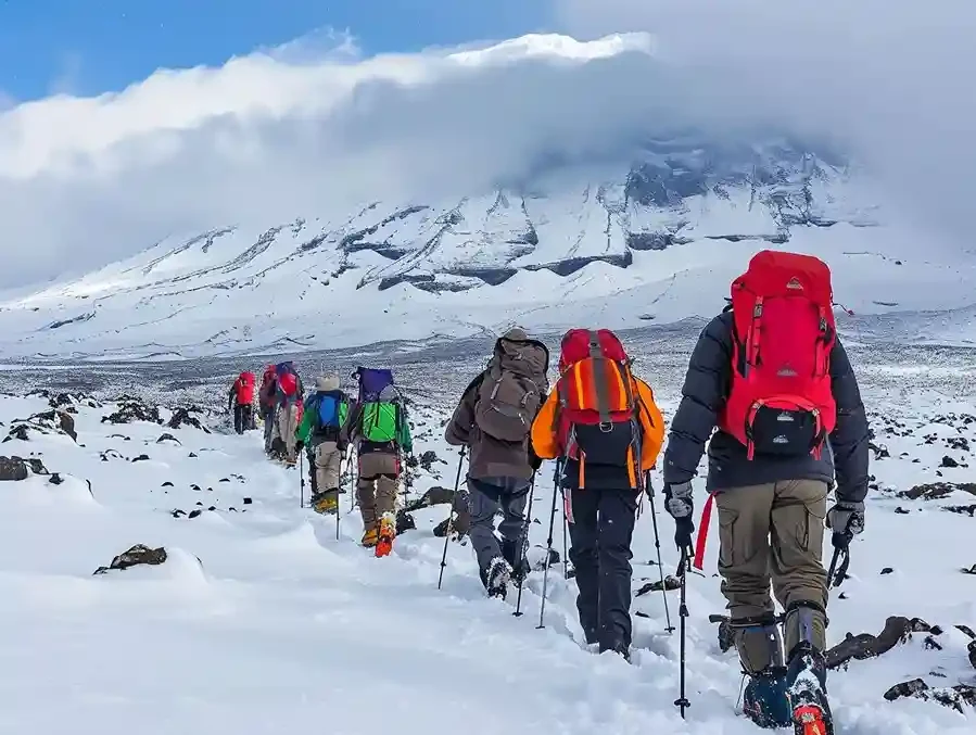 Expert guide leading climbers on Mount Kilimanjaro
