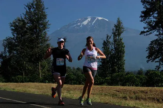 Runners in the Kilimanjaro Marathon with Mount Kilimanjaro in the background
