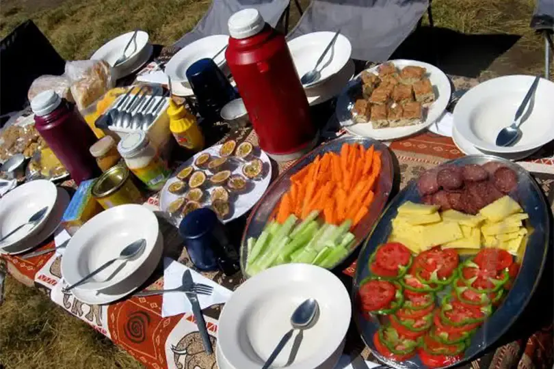 Trekker enjoying a meal in a dining tent on Mount Kilimanjaro