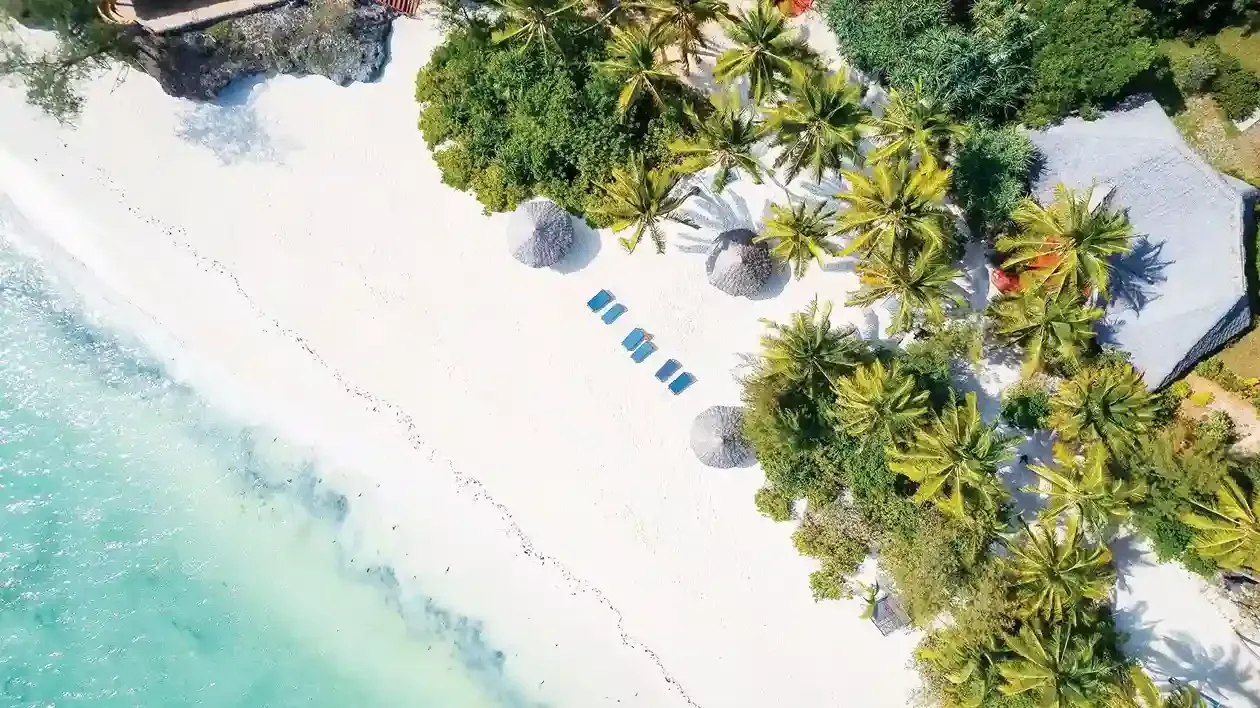 Pristine Matemwe Beach with turquoise waters and luxury resort views near Mnemba Atoll